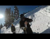 Guy on skis records himself do flip while drink beer