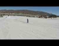 Man blue jacket ski board jump on a ramp
