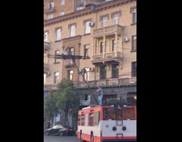 Man on top of tram trying to fix it