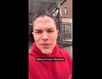 Man walks on Manhattan and eats food along the way