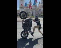 Motorcyclist does a wheelie on Vegas freeway with feet hanging off 