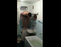 Guy jumps into filled white bathtub tub 