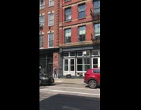 Blue jacket guy plays violin outside sidewalk 