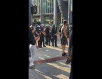Guy tank top near police line protest