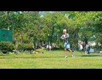 Black white striped shirt guy dances park 