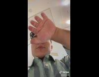 Man with dwarfism shows friends 