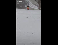 Guy rides toy car across snow 