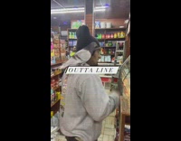 Man walks into bodega with pigeon on shoulder 