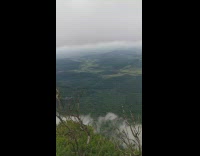 Mountain view green fields cloud nearby overcast