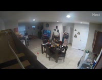 Woman with mask scares cat on table