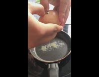 Egg cracked double yolk on small pan