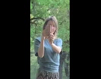 Woman blue shirt pout lips selfie backyard