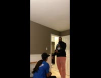 Girl blue shirt has coca cola font hat says enjoy cocaine