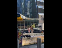 Woman stands at barricade dance films video