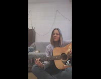Guinea pig lays down behind girl playing guitar 