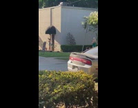 Black shirt girl brown building awning sunset