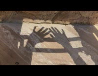 Hands on the sun chair with pixelized shadow