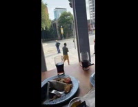 Yellow shorts guy poses sidewalk restaurant backpack 