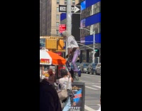 Man gray wig dance over trash bin