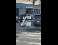 Man push large mattress on the street