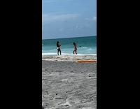 Red bikini girl beach orange pool noodle 