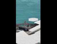 Woman bikini dances at bar near beach