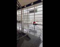Woman yoga exercise beside airport water fountain