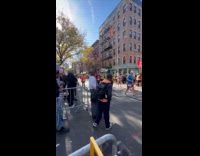 Policeman helps people cross road at marathon