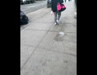 Guy wears brown shirt and pants sidewalk 