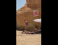 Black white striped speedo guy dances beach