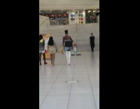 Guy walks in high boots and pride streamers 