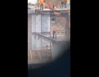 Man cut metal beam at demolition site