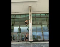 Six guys climb white pole column building