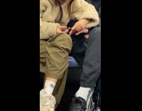 Couple hold hands cut nails inside train