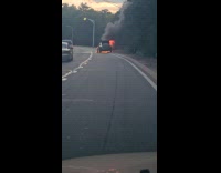 Submitter shows burning car on road side 