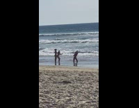 Woman bikini kneel and raise arm beach