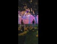 Girl dress sit on hay hold pumpkin