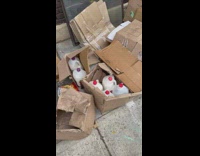 Broken boxes with gallons of milk inside