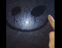 Guy draws smiley face on wet car window, smiley face starts crying