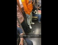 Guy wears new jeans with tag on subway 