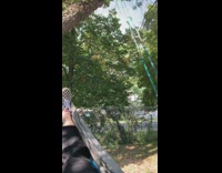 Girl in hammock watches baby swing tree 