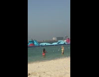 Beach inflatable obstacle course girls posing 