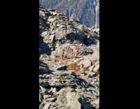 Woman pink outfit dances on rocky alps