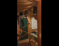 Guy on skateboard balancing on lopsided table in room falls