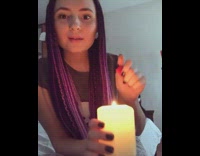 Girl uses lighter on smoke white candle 