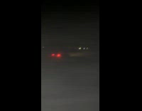 Car drives over bump in grass jumps in air 