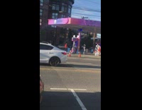 People in Robotic Costumes Dance at Gas Station 