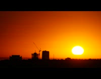 Time lapse sunrise construction crane yellow sky