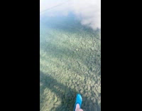 Guy walk on clear frozen lake water
