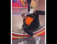 Guy does a handstand inside of giant hamster wheel and falls backwards 